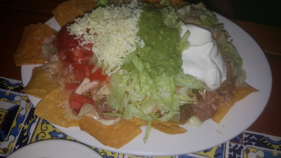 Nachos, tacos, and enchiladas listed on menu.